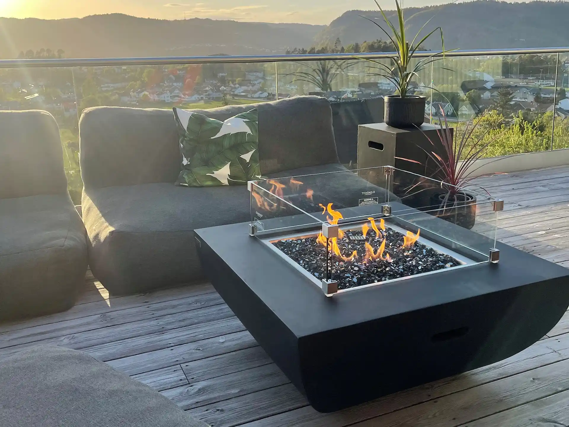 The same piece outdoors across the seasons — sun, rain, frost. One frame that carries frost, UV and moisture without a caption.